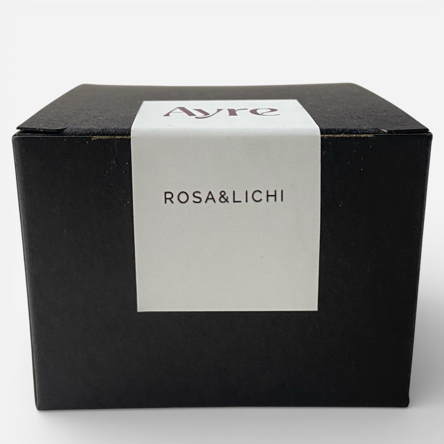 Caja de presentación de la vela aromática de soja Rosa y Lichi Ayre.