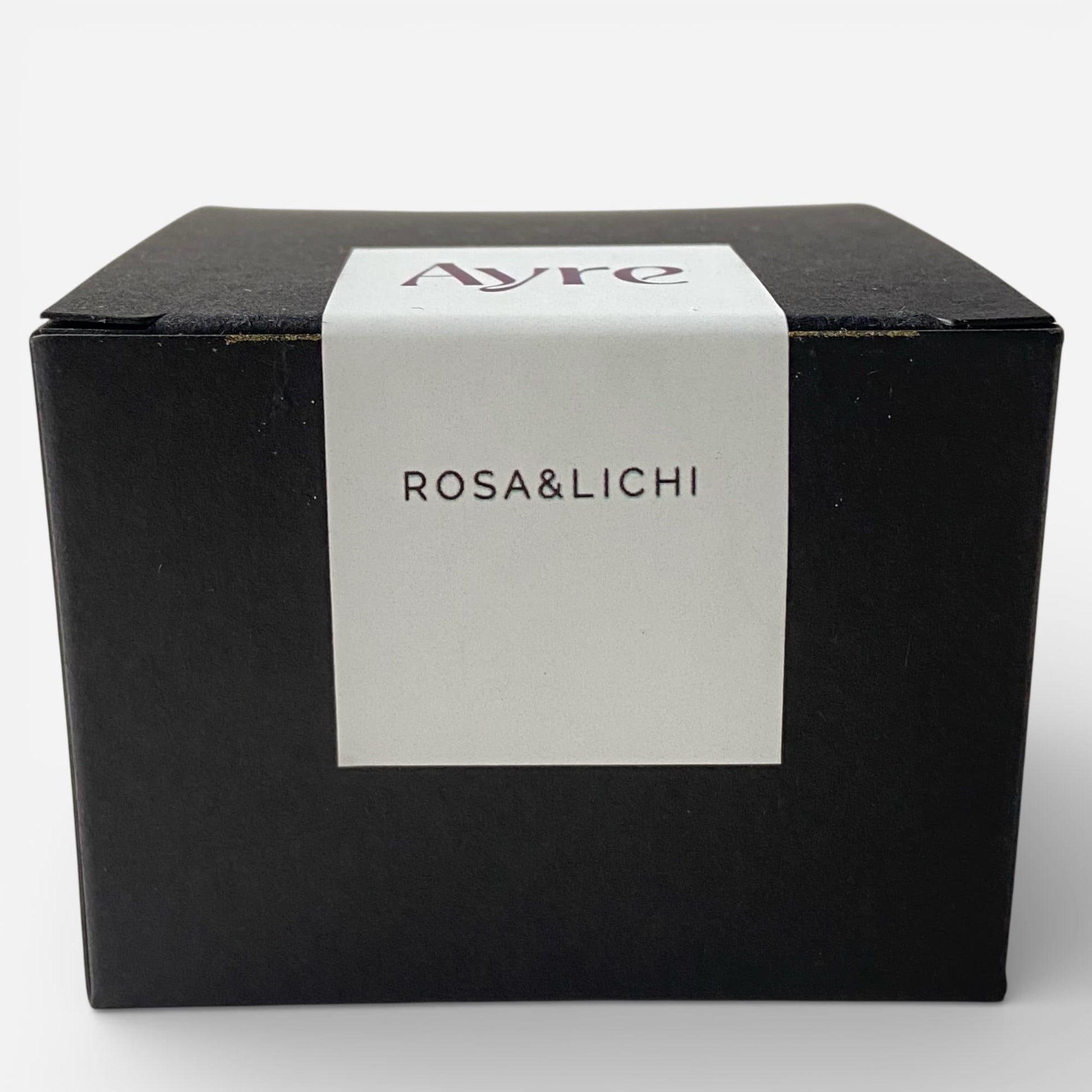 Caja de presentación de la vela aromática de soja Rosa y Lichi Ayre.
